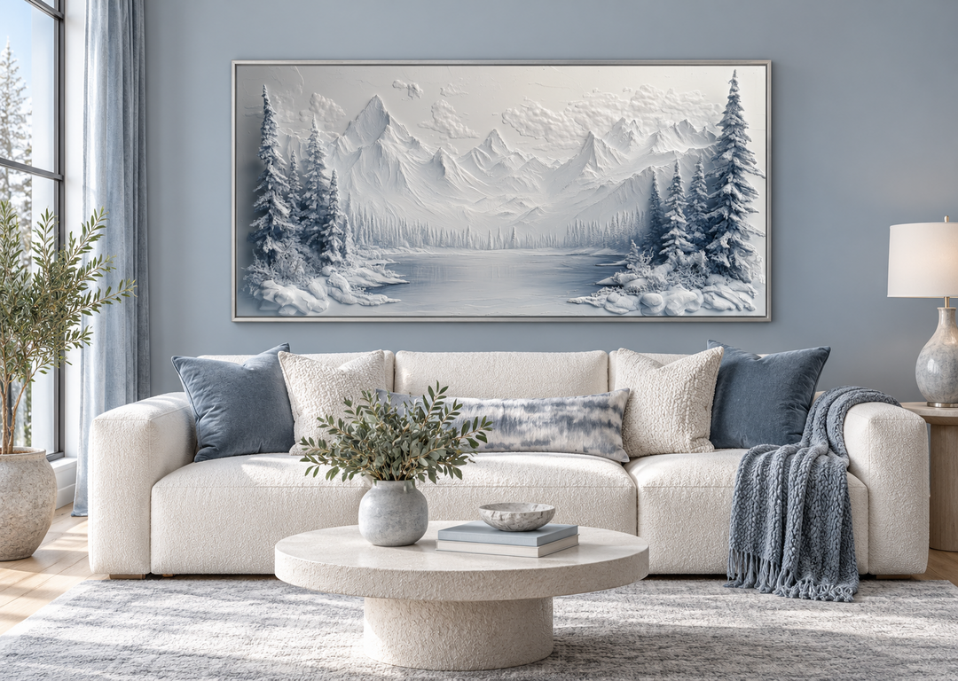 Snowy mountain lake with pine trees winter framed canvas wall art above a white sofa.