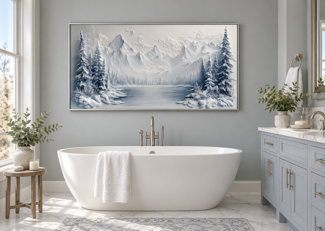 Snowy mountain lake with pine trees winter framed canvas wall art hanging above a white bathtub.