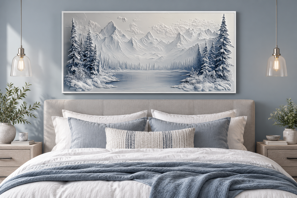 Snowy mountain lake with pine trees winter framed canvas wall art hanging above a bed.