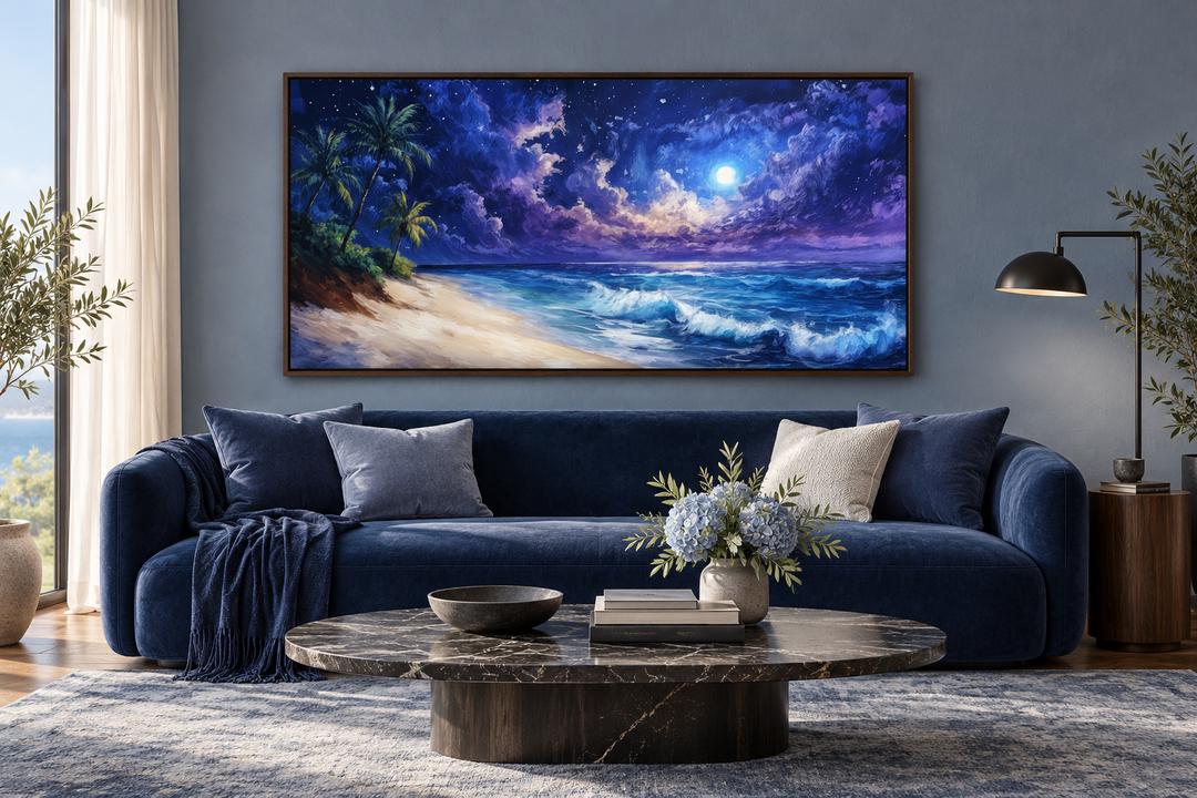 Tropical beach at night under a starry sky framed canvas wall art above a blue sofa.