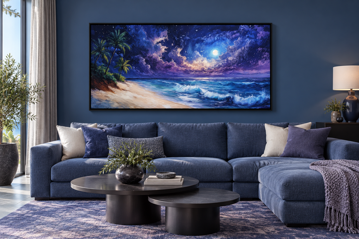 Tropical beach at night under starry sky framed canvas wall art above a blue sectional sofa.