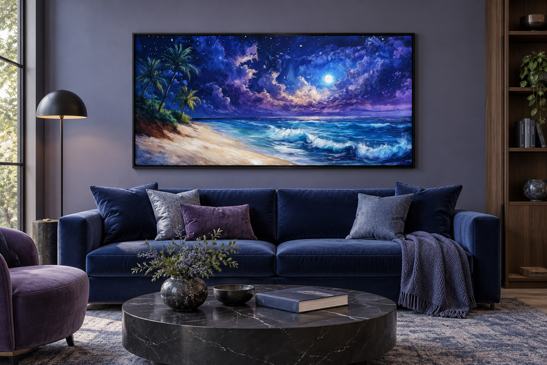 Tropical beach at night under starry sky framed canvas wall art above a blue sofa in a modern room.