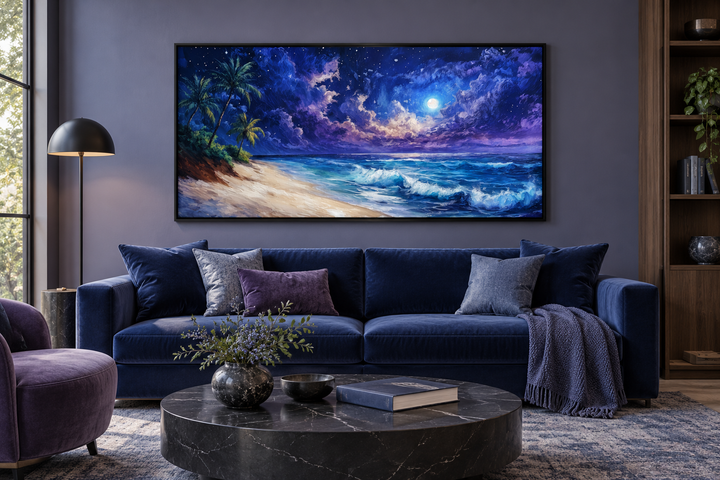 Tropical beach at night under starry sky framed canvas wall art above a blue sofa in a modern room.