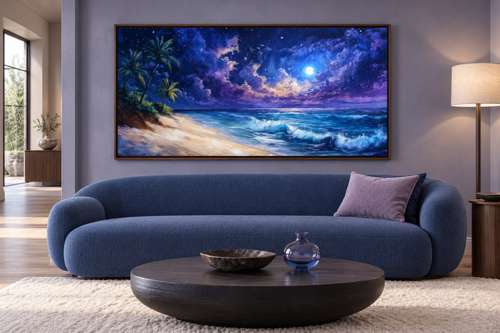 Panoramic framed canvas wall art of a tropical beach at night under a starry sky above a blue sofa.