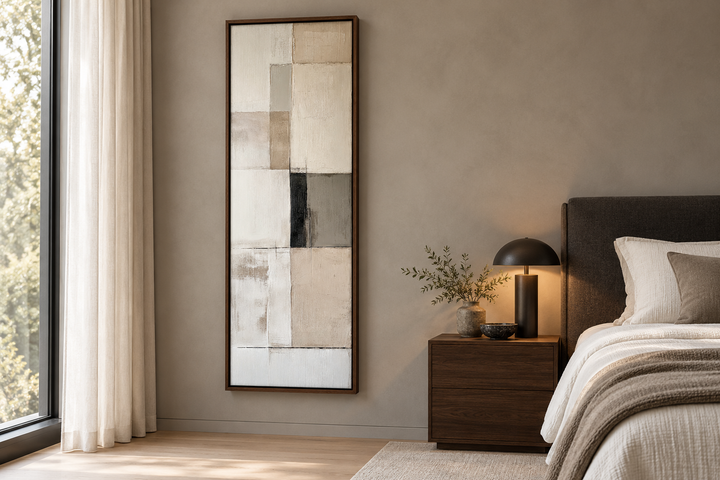 Vertical abstract geometric wall art in neutral beige, black, and white tones with a walnut frame.