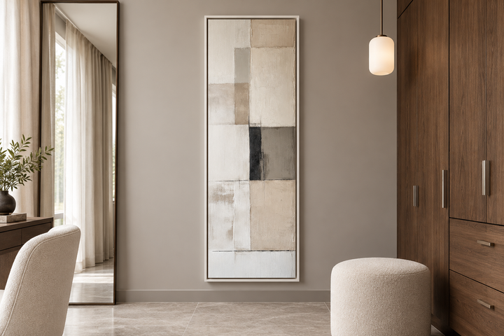 Vertical abstract geometric wall art in beige, black, and white, framed in a modern dressing room.
