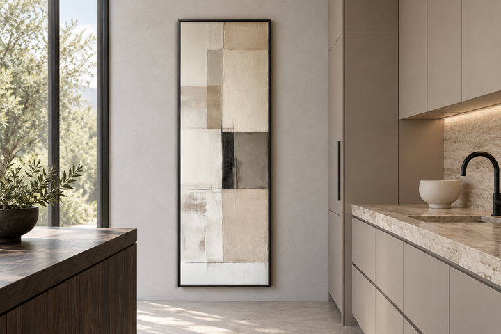 Vertical abstract geometric wall art in beige, black, and white with a black frame in a kitchen.