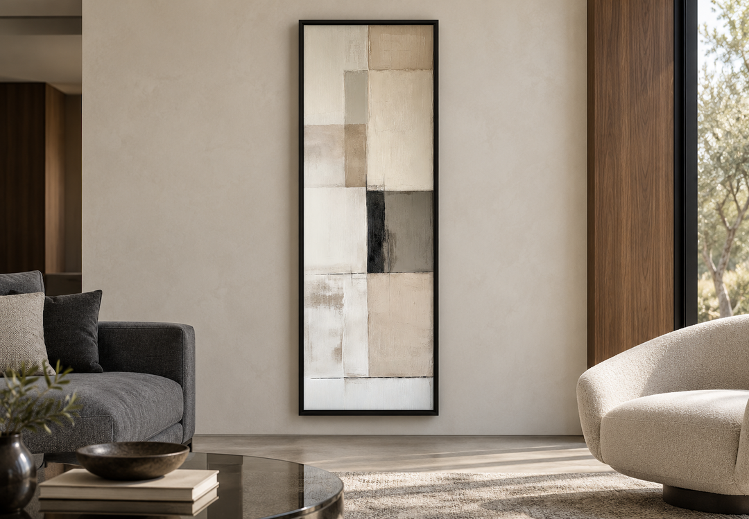Vertical abstract geometric wall art with beige, black, and white panels in a black frame.