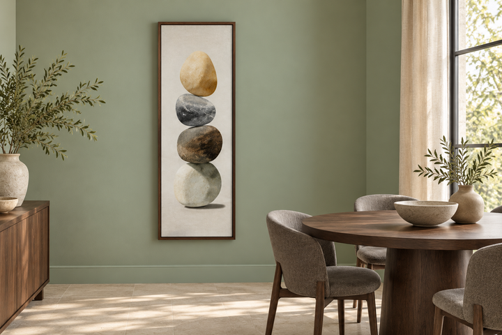 Vertical Zen Stacked Stones Canvas Wall Art in a dark wood frame on a sage green wall.