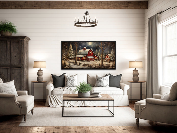 Snowy Farm Barn Painting On Wood Canvas Wall Art "Christmas Retreat" hanging over rustic couch